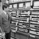 A sales clerk at an electronics store in the Akihabara district of Tokyo, Japan, displays a stack of video cassette recorders (VCR), which are on sale for 20 to 30 percent off, Dec. 15, 1981.